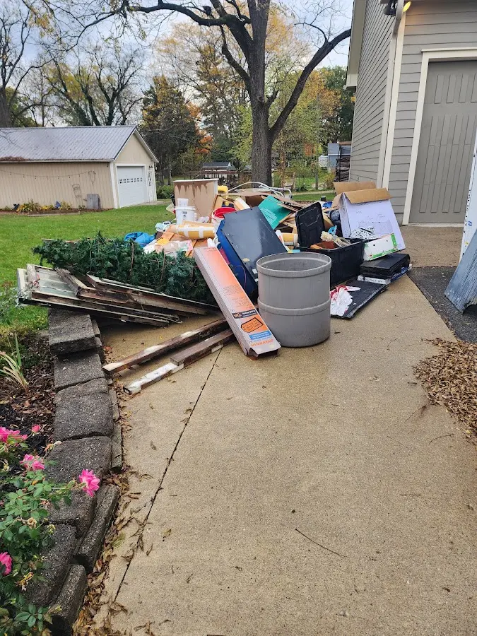 Dumpster being loaded with debris for 12 Yard Dumpster Rental in Clyde Hill